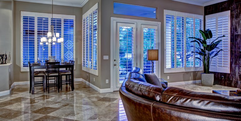 Virginia Beach great room with plantation shutters and tile floor.